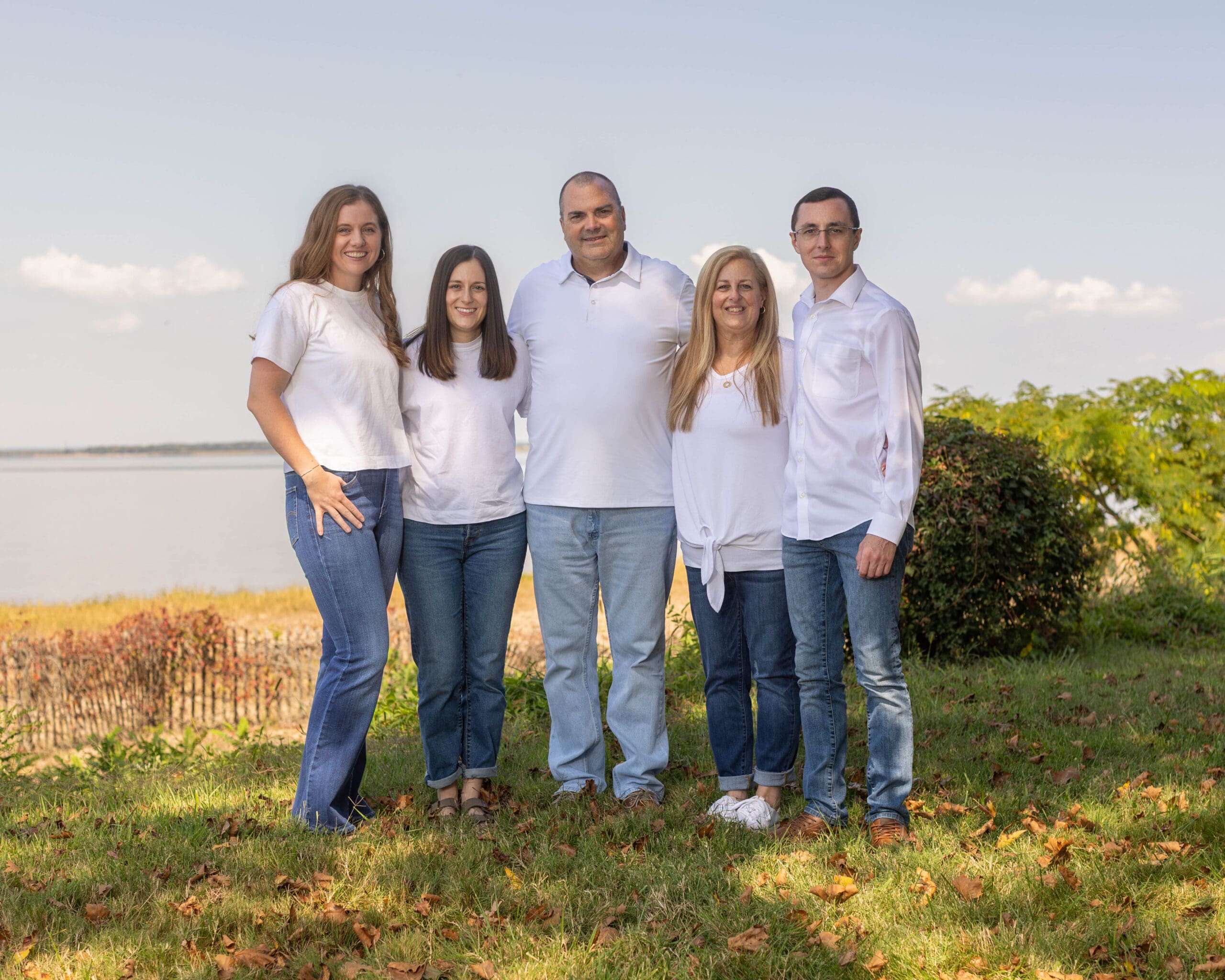A family of 5 standing on a New Jersey beach for a portrait photographer
