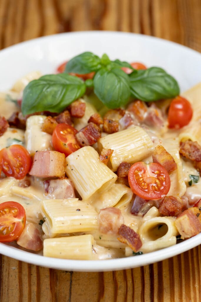 Rigatoni pasta with diced pancetta and tomatoes.