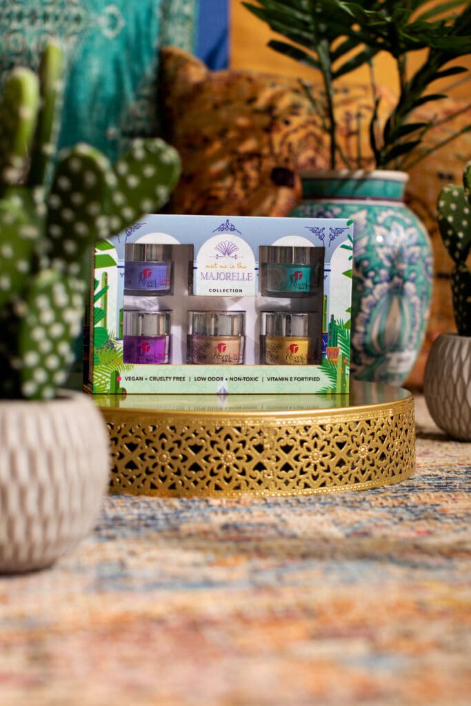 A dip powder nail set sitting in a Marjorelle themed set for e-commerce photography. 