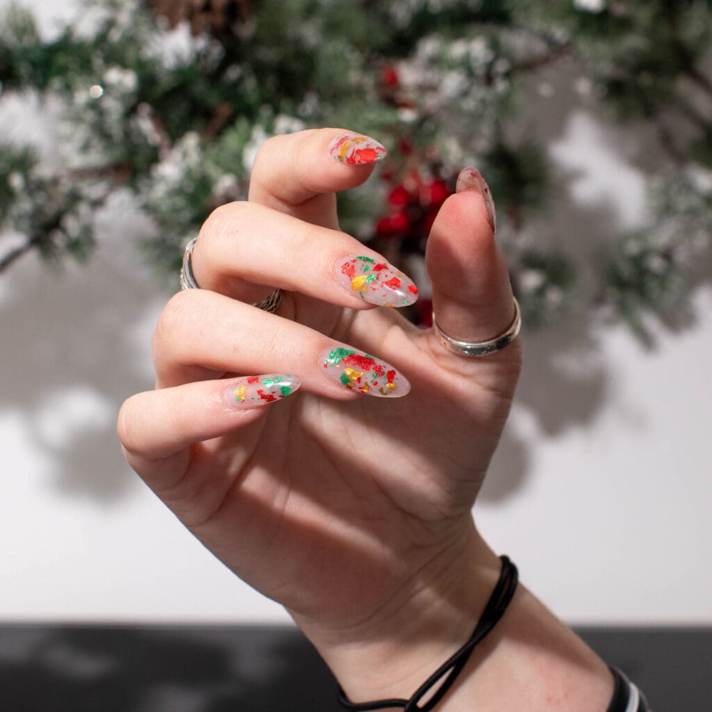 A female hand model in a holiday theme photo set up.